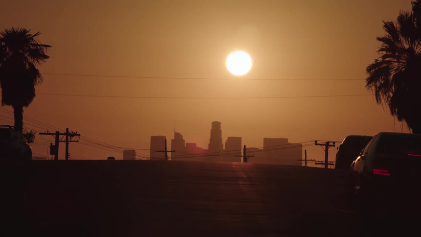 Sun setting over city skyline