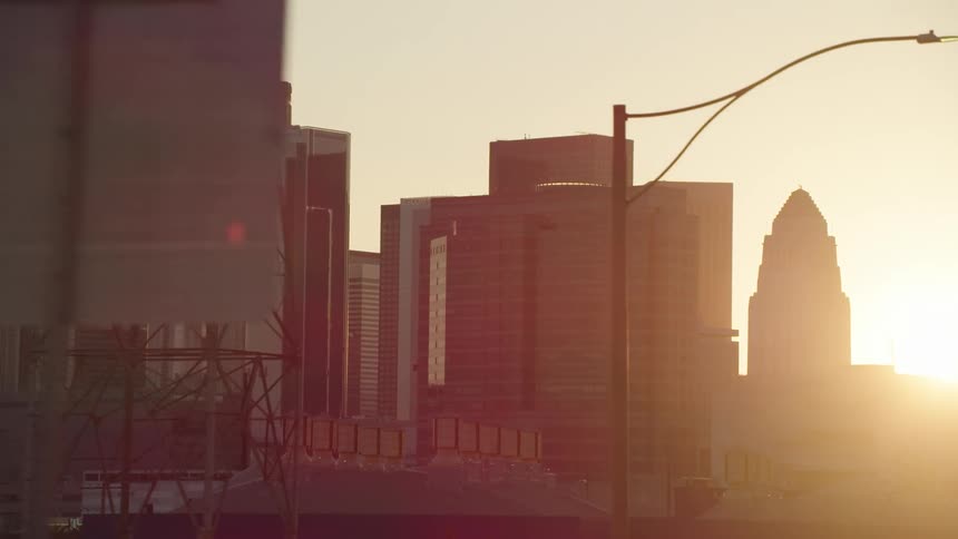 Sun sets over city skyline