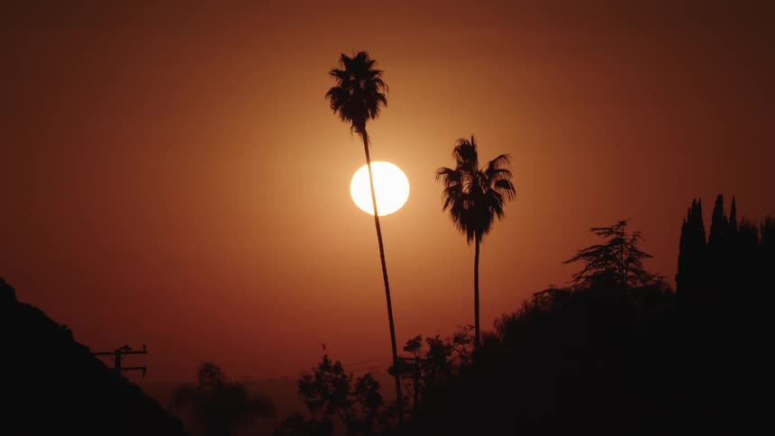 The sun sets in a tropical area