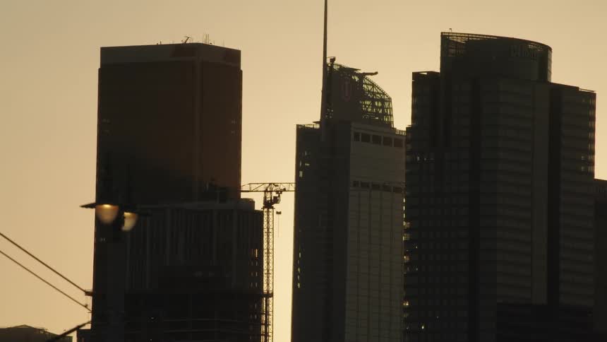 Tall city office buildings against dawn sky