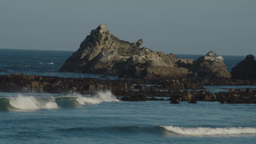 The rocks point up out of the ocean