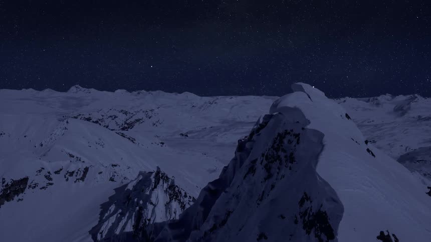 Aerial view of snow covered mountains at night under the stars