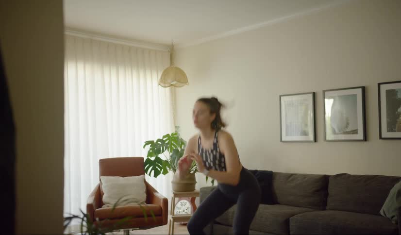 Woman exercising in her living room