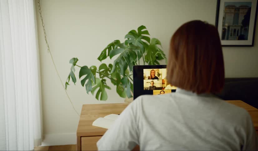 Woman working from home has teleconference on laptop