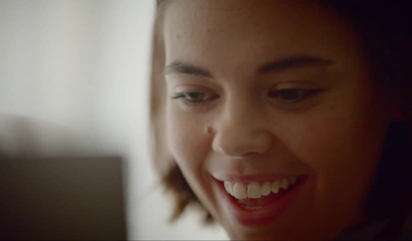 Woman greets someone on a video call