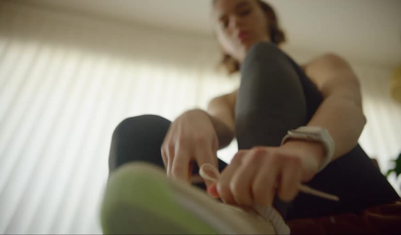 A teenager ties her shoes