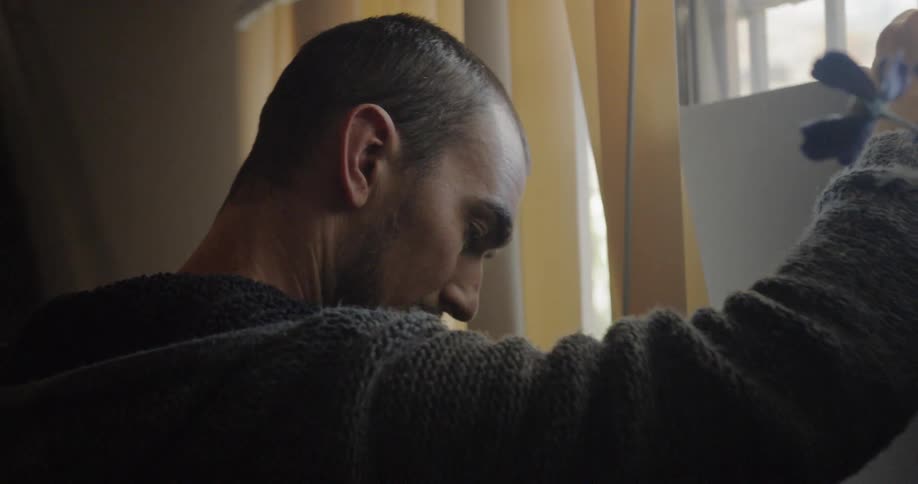 A man opens up vertical blinds