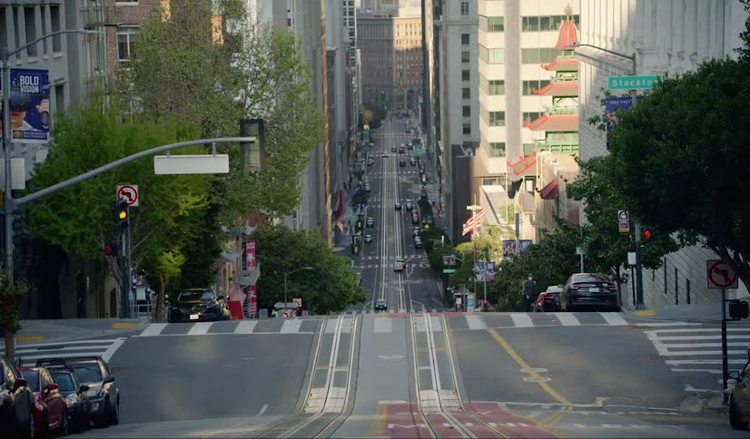 A pedestrian and cars on a city street