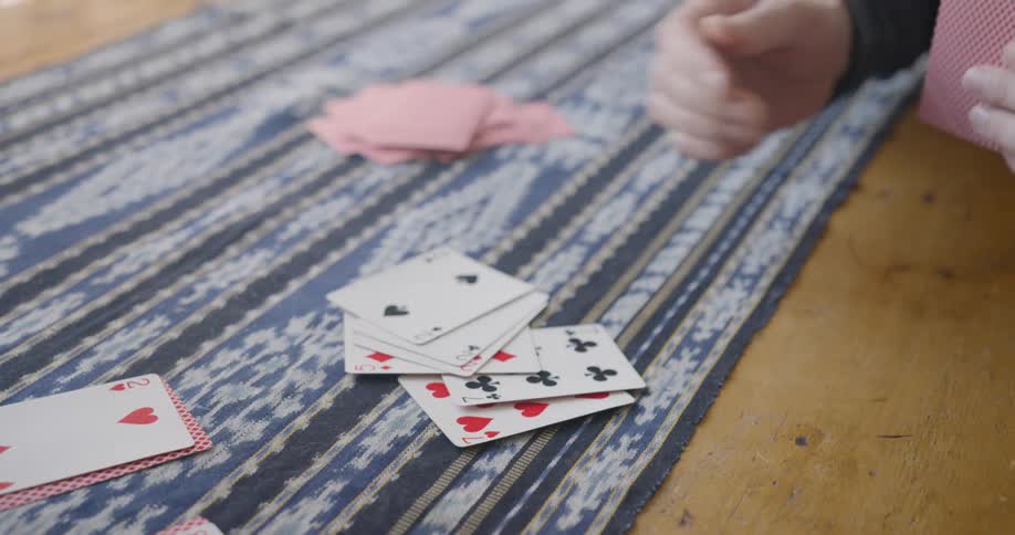 Close up of a person playing a card game