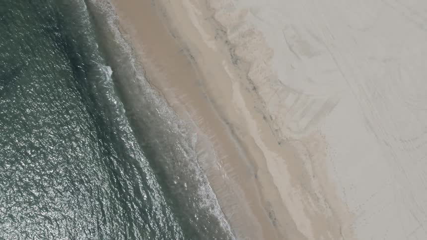 An empty sandy beach during the day