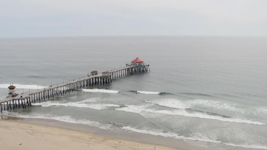 A pier stretches out over the ocean