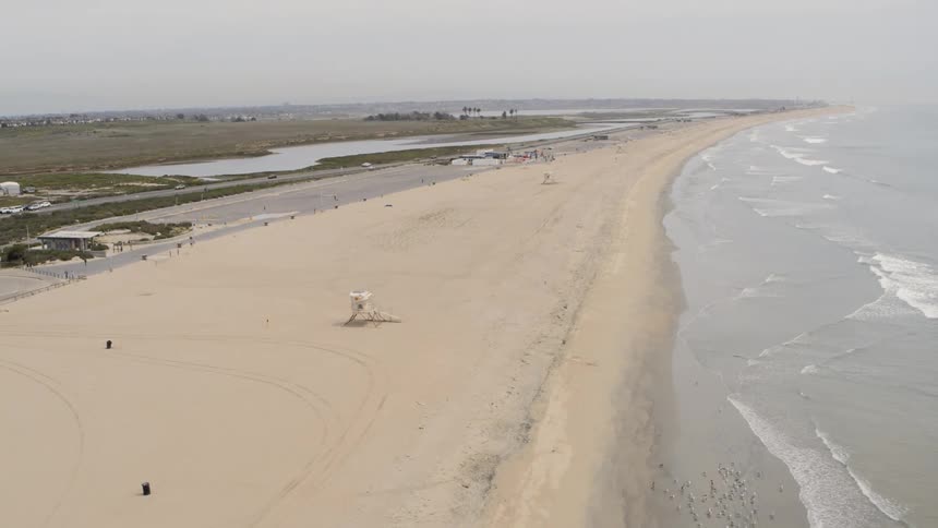 Waves roll into a sandy beach