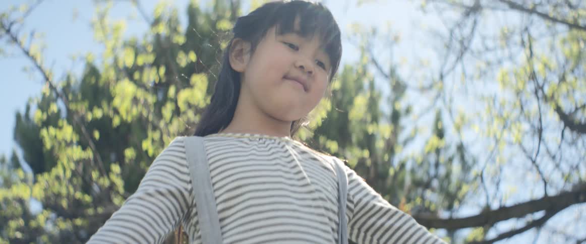 Asian little girl play outdoors on a sunny day