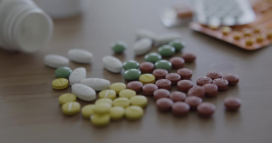 Colorful pills spilled out on the table