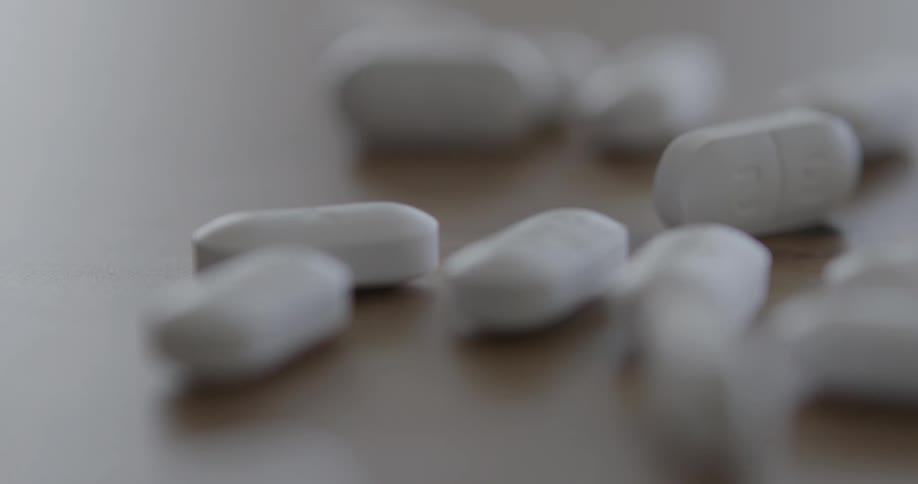 Pills pour out over the table