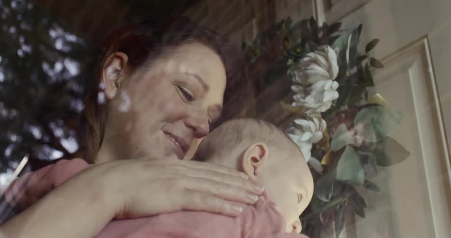 A mother caresses her baby