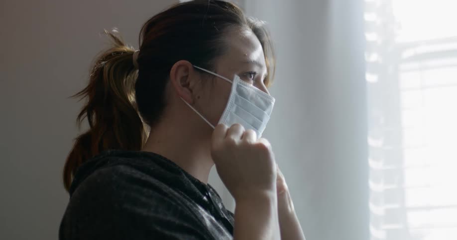 A person attaching a face mask