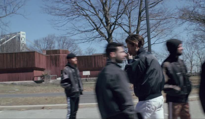 A man grabs a gun out of the car