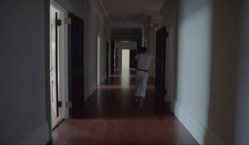 A man has trouble walking down the hallway