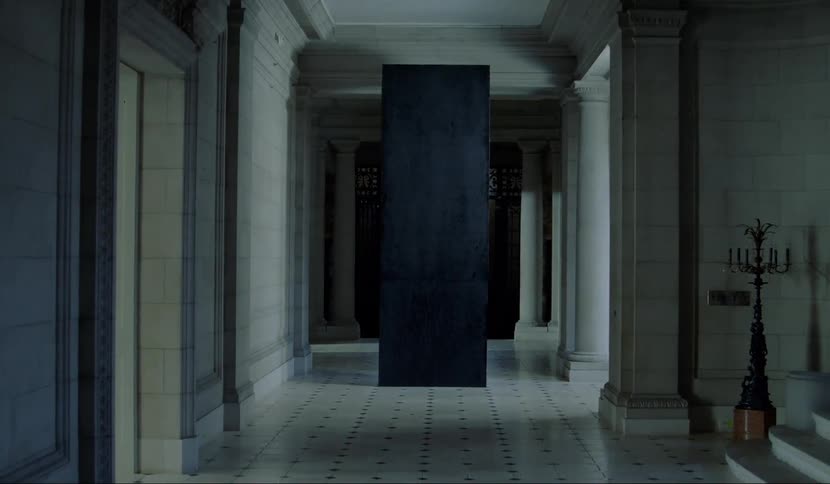 A tall black box sits at the end of a hallway inside a historic building
