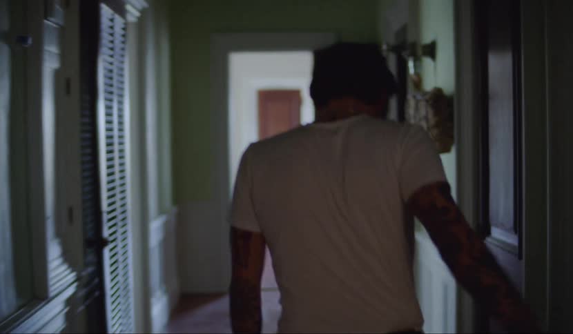A man is stumbling inside a house