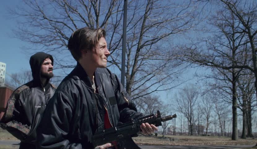A man pretends to fire a gun