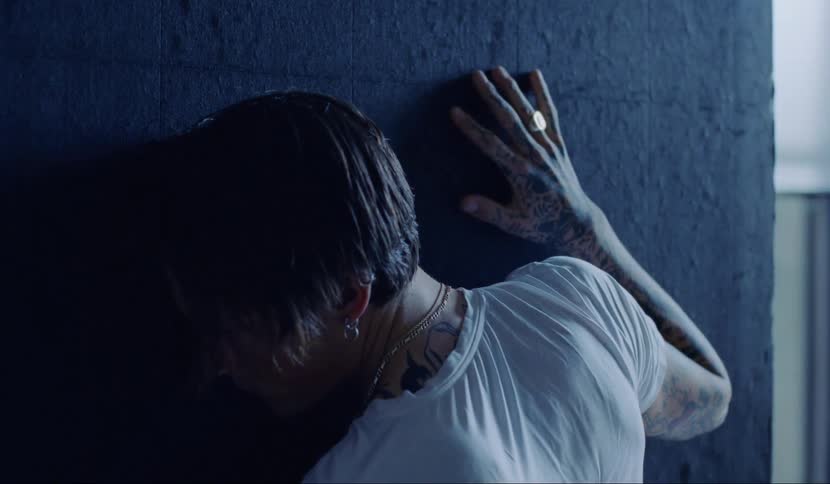 A man is holding onto a wall