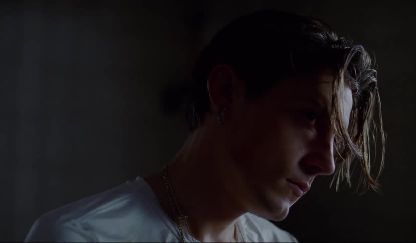 A man looks up and stares with his head cocked to the side