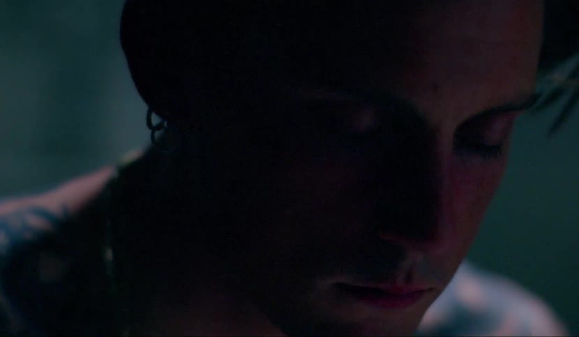 A man sits in the darkness
