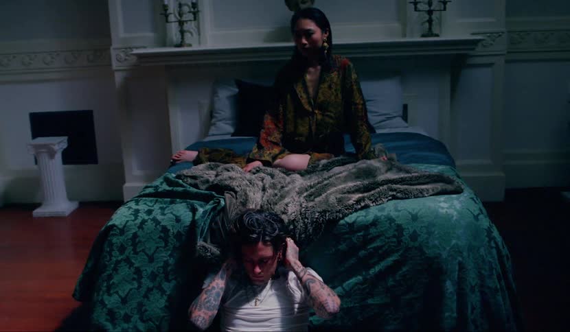 A woman and man are sitting in a dark lit room