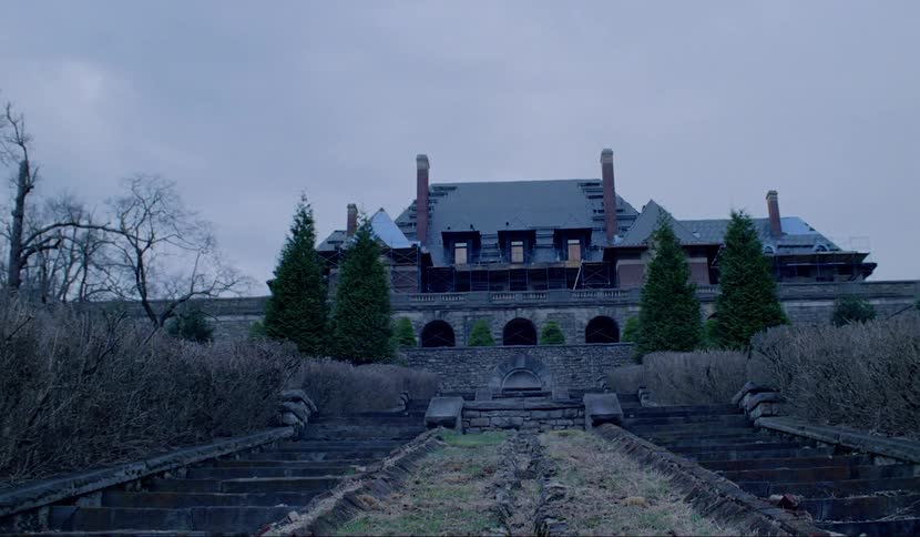 Steps leading to abandoned mansion at the top of a hill