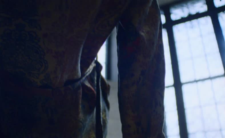 A person hangs near a window
