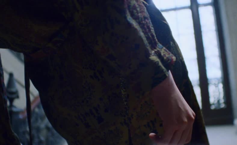 A female teenager hangs from a staircase
