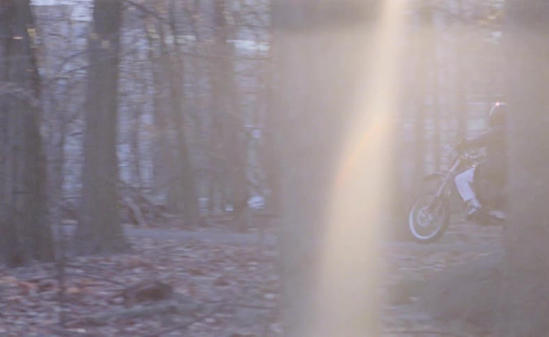 A person riding a motorcycle in a park