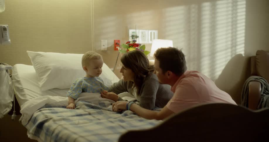 Parents visit their son in the hospital room
