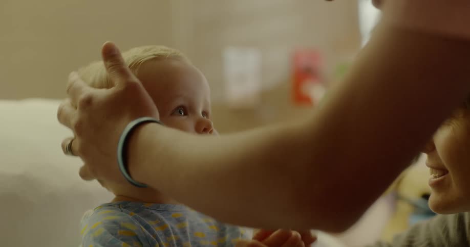 Father and mother care for child lying in hospital bed