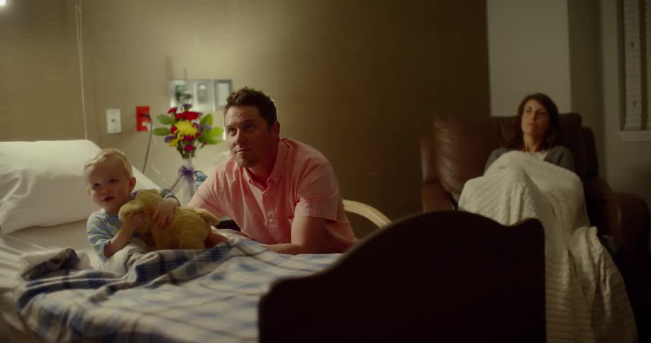 Father and mother focus on doctor coming to consult in hospital room