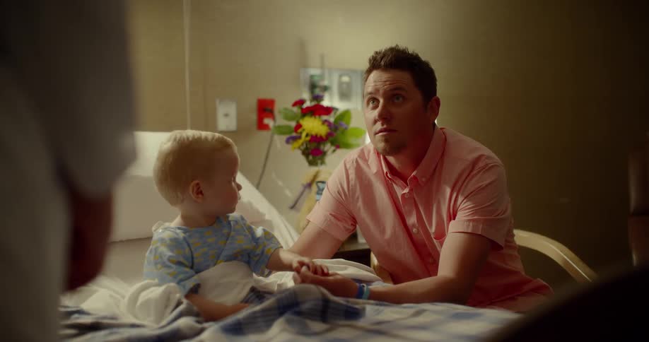 Parents listen to doctor in childs hospital room