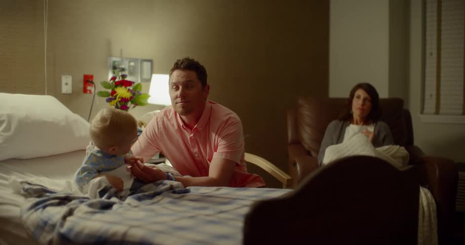 A doctor enters a room with a family