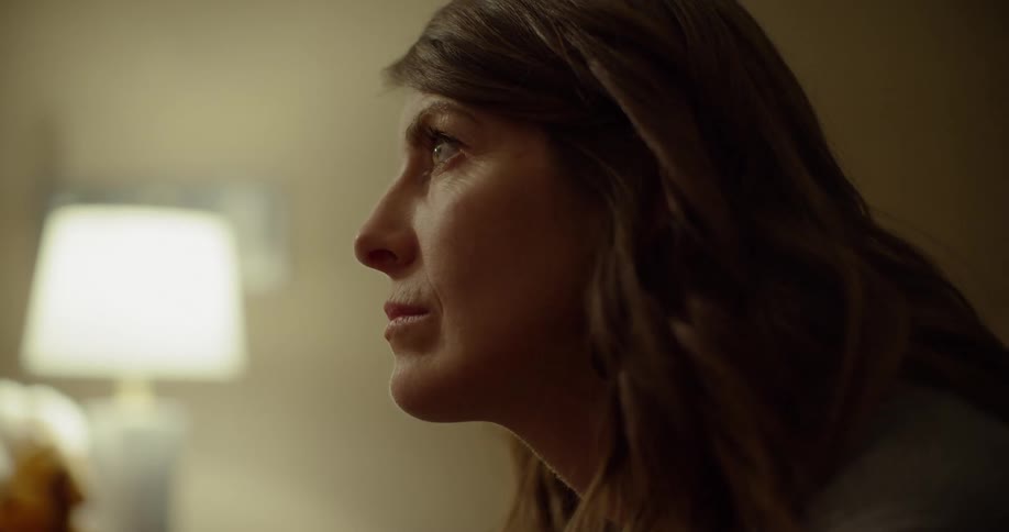 A woman stares while nodding