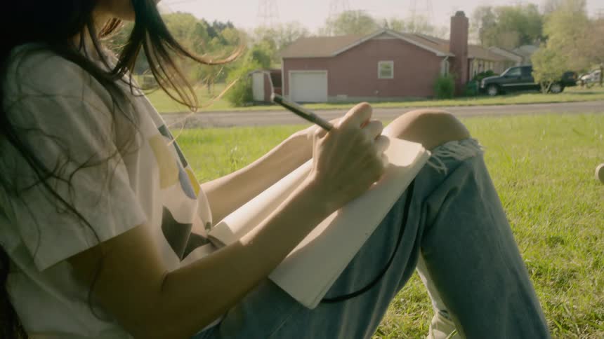 A man reading out loud while a woman writes