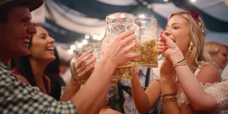 People toast their beers and laugh