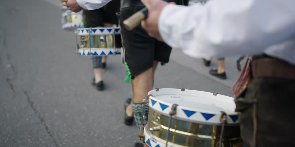 Drummers march while hitting the drums
