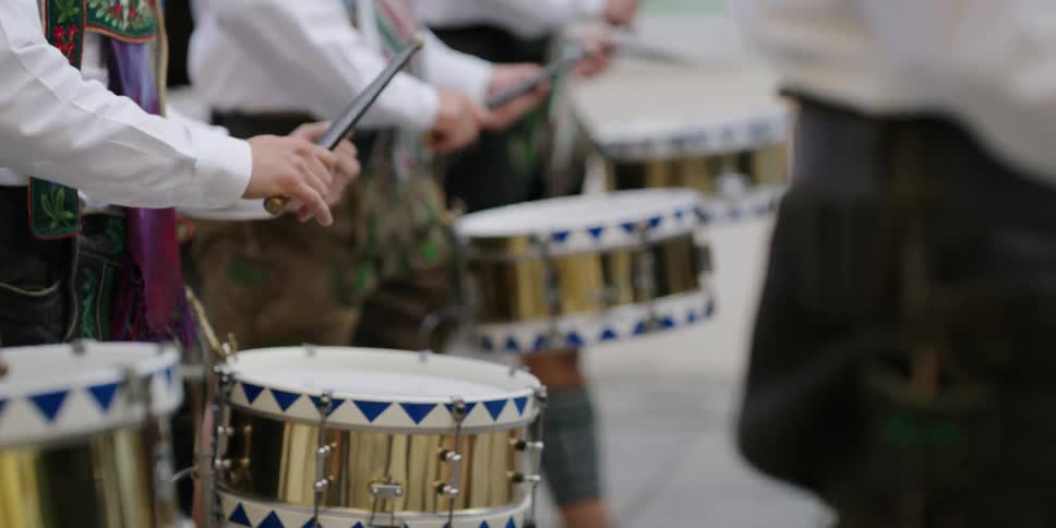 Drummers marching in oktoberfest event wearing german costumes