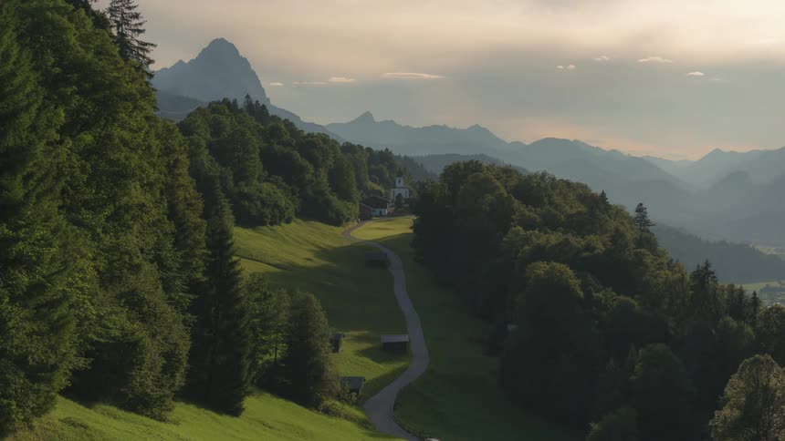 Time lapse of clouds over forest covered mountains