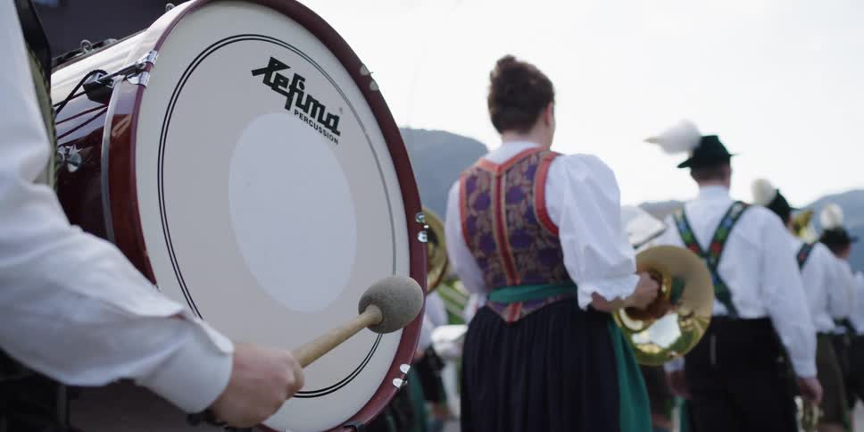 Band members dressed in costumes for oktoberfest play instruments
