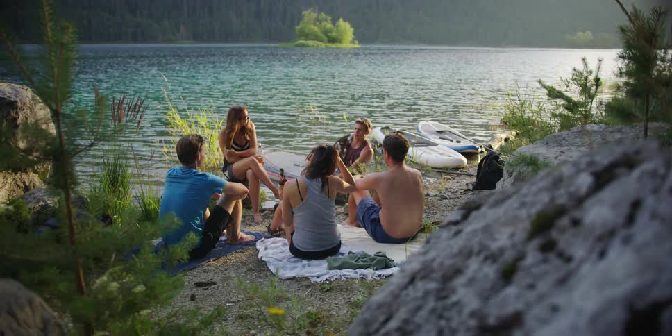 Friends camping near in the mountains near lake