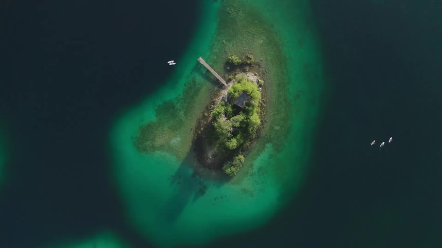 Birds eye view of boats around an island