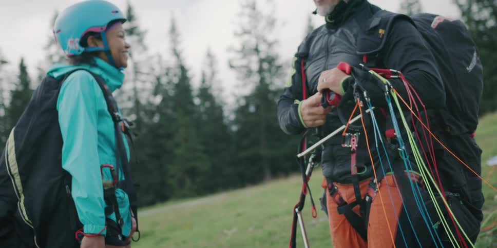 Two people removing items from their hanggliding setup