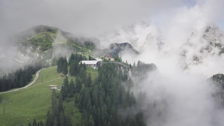 Aerial shot of a house on top of a mountain